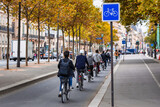 Fototapeta Londyn - Cyclists on the bike path along the Seine in Paris. France