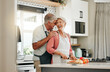 © Kay Abrahams/peopleimages.com - Senior couple in kitchen, cooking healthy food together and happy in retirement lifestyle. Elderly woman chopping vegetables with apron, old white man hug wife in home and love nutrition dinner meal