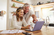 © N Lawrenson/peopleimages.com - Happy pension couple with laptop and paperwork for retirement planning, online ecommerce website or digital bank application investment. Elderly, senior people for life insurance or asset management