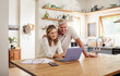 © Nina Lawrenson/peopleimages.com - Happy couple budget, laptop finance and tax while planning investment, loan and paperwork bills in home kitchen. Mature man, smile woman and online banking technology, ecommerce and retirement admin