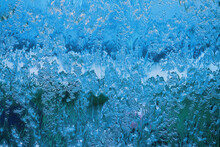 Water Cascading Over The Glass Of A Water Feature