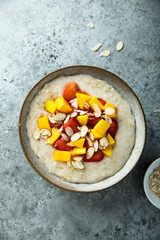 Wall Mural - Homemade oatmeal porridge with strawberry and mango