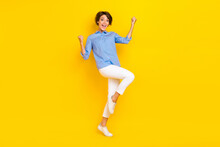 Full Length Photo Of Lucky Excited Girl Dressed Blue Shirt Rising Fists Screaming Isolated Yellow Color Background