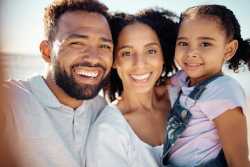 Poster - Happy, black family and smile for beach selfie in happiness together on a summer vacation in the outdoors. Portrait of a African man and woman holding little girl smiling for bonding love and care