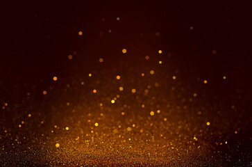 particles on a dark brown background. glitter background