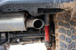 SUV car exhaust muffler or resonator and tip. Low angle view, no people