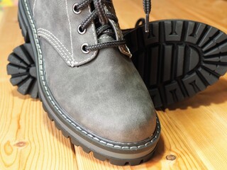 Winter shoes on a wooden background. Shoe care