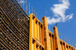 © Mint Images - The exterior of a construction site, a high rise building, rebar concrete shuttering and metal mesh grids for building.