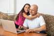 © Angelov - Grandfather and granddaughter spend time together use laptop, browse website, younger generation teach explain to older how to use modern tech concept