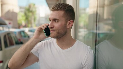 Sticker - Young caucasian man smiling confident talking on the smartphone at street