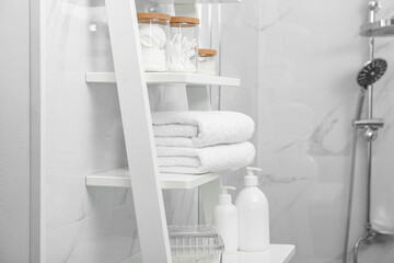 Poster - Stacked bath towels on white shelf in bathroom