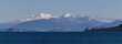 Snow capped volcanoes over lake Taupo