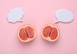 Gynecology, female intimate hygiene. Halves of ripe grapefruit symbolizing the female vagina and empty speech bubble on a pink background. Top view