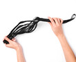 Female hands hold a leather whip from sex shop on a white background