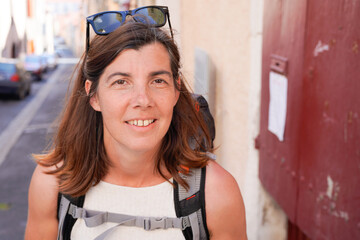 Beautiful woman middle aged tourist in city street happy laughing