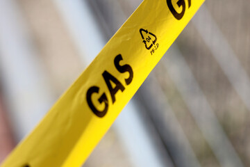 yellow barrier tape with text Gas at pipe leakage incident