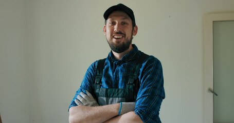 Sticker - Portrait of a smiling man hired to work on a construction site. The man is standing in a room undergoing demolition resting. break from the renovations.