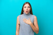 Young Lithuanian woman isolated on blue background surprised and shocked while looking right