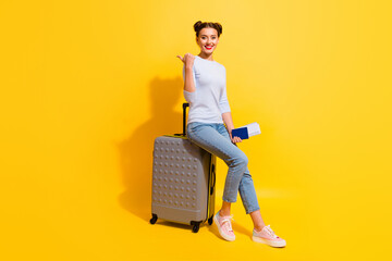 Wall Mural - Photo of positive lady sitting on bag hold passport wait verification direct way finger isolated shine color background