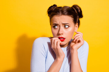 Wall Mural - portrait of scared anxious girl look blank space see bad person bite her fingers in fear isolated on