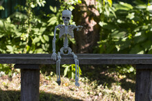A Skeleton Sitting On A Bench. Celebrating Halloween