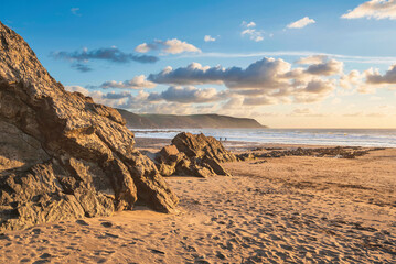 Wall Mural - Stunning Summer sunset landscape image of Widemouth Bay in Devon England with golden hour light on beach