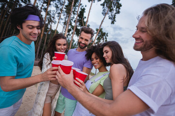 Wall Mural - Photo of young guys ladies stand drink beer wear casual outfil outside on the beach