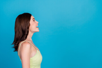 Sticker - Profile photo of astonished cheerful person toothy smile look interested empty space isolated on blue color background