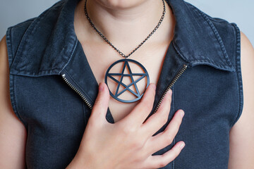 Wall Mural - Woman wearing a black pentagram pendant