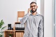 © Krakenimages.com - Young hispanic man business worker talking on smartphone working at office