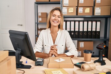 Canvas Print - Young blonde woman working at small business ecommerce with a happy and cool smile on face. lucky person.