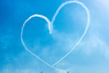 Two Light Airplanes In The Sky Writing Romantic Heart Shape