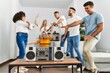 © Krakenimages.com - Group of young friends smiling happy and dancing at home.