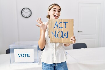 Poster - Young blonde woman at political election holding act now banner celebrating victory with happy smile and winner expression with raised hands