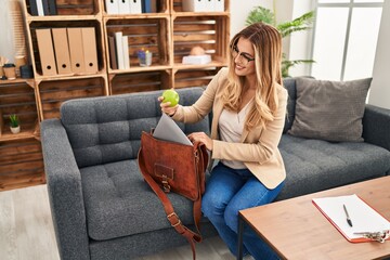 Sticker - Young blonde woman psychologist holding apple of briefcase at psychology center