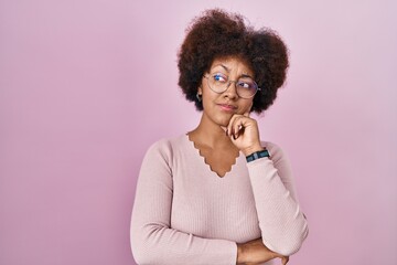 Poster - Young african american woman standing over pink background thinking worried about a question, concerned and nervous with hand on chin