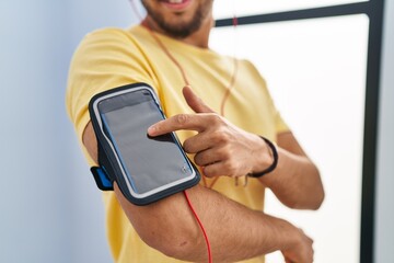 Sticker - Young arab man listening to music standing at sport center