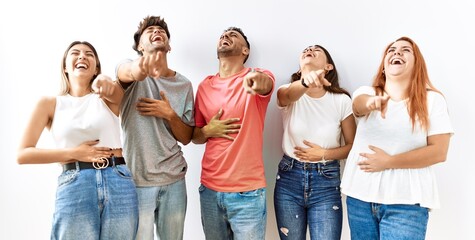 Sticker - Group of young friends standing together over isolated background laughing at you, pointing finger to the camera with hand over body, shame expression