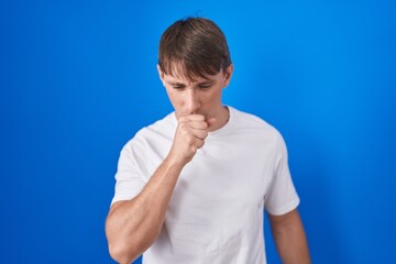 Sticker - Caucasian blond man standing over blue background feeling unwell and coughing as symptom for cold or bronchitis. health care concept.