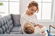 © Krakenimages.com - Mother and son breastfeeding kid sitting on sofa at home