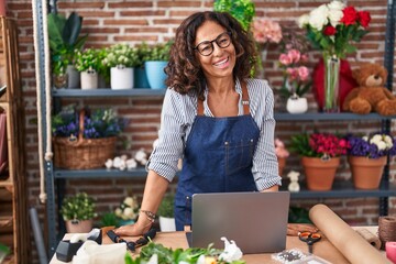 Wall Mural - Middle age woman florist smiling confident standing at flower shop