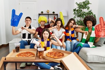 Poster - Group of young people wearing team scarf cheering football game with angry face, negative sign showing dislike with thumbs down, rejection concept