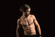 © velimir - young sexy muscular man with a naked torso on a dark background. Long-haired man sportsman.