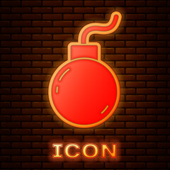 Poster - Glowing neon Bomb ready to explode icon isolated on brick wall background. Vector