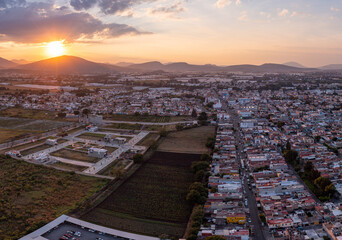 Wall Mural - Aerial: epic sunset in the mountains and cityscape. Drone view