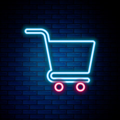 Poster - glowing neon line shopping cart icon isolated on brick wall background. online buying concept. deliv