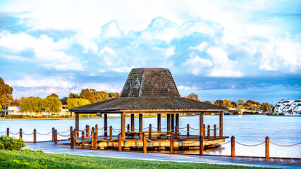 Wall Mural - Amazing cloudscape by the gazebo at the lake 