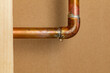 Copper plumbing pipe leaking water inside wall. Home repair, maintenance and remodeling concept.