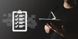 © alongzo - Business owner checklist on tablet with data virtual screen.