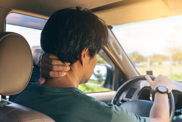 Man driver having Neck Pain after a long road trip car drive.